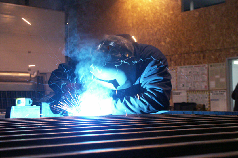 Man in workshop welding metal together 