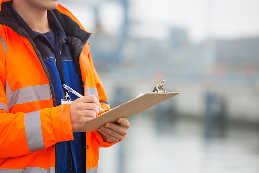 Man with a checklist conducting a legal audit 
